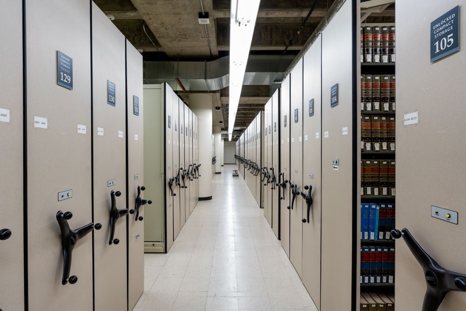 Spacious library archive with organized compact shelving and storage units.